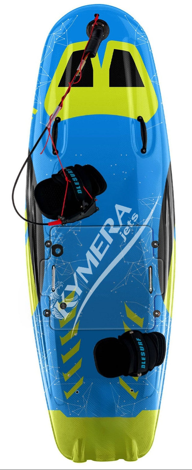 A water sports accessory kit on a white background, featuring a blue and yellow wakeboard with 'KOMERA PRO' printed on it, a black padded pad, a black life vest, knee pads, wrist guards, straps, a battery charger, and two black storage cases with blue lids.
